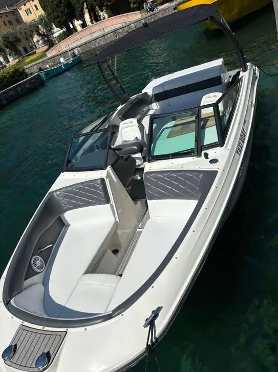 Private open-style motorboat moored at a lakeside dock, Lake Garda boat tour vessel