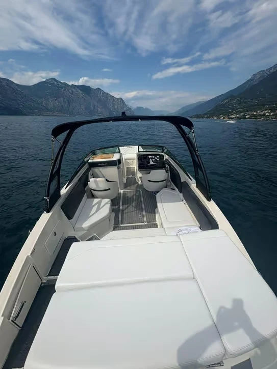 White private motorboat with sun deck and mountain views on Lake Garda