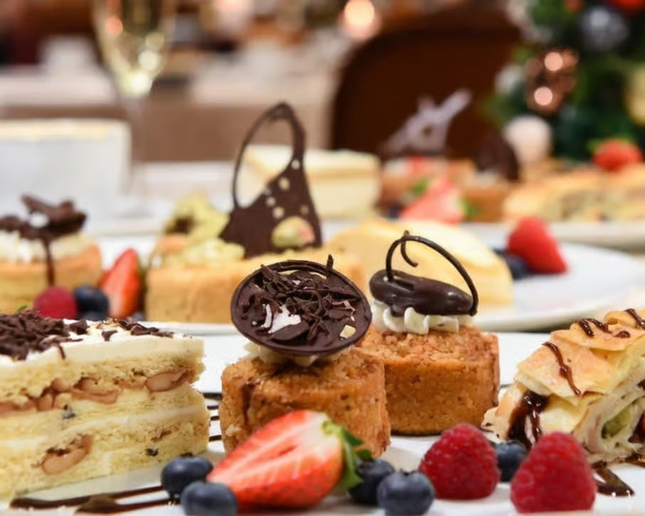 Assorted elegant cakes and pastries with fruit served as dessert during a festive gala dinner