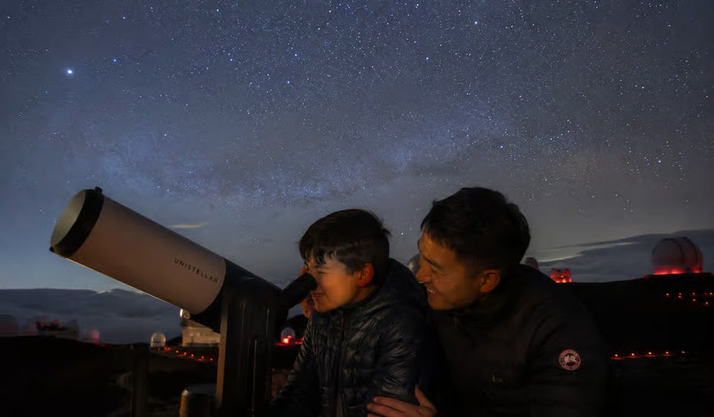 Guest looking through telescope under the Hawaiian stars