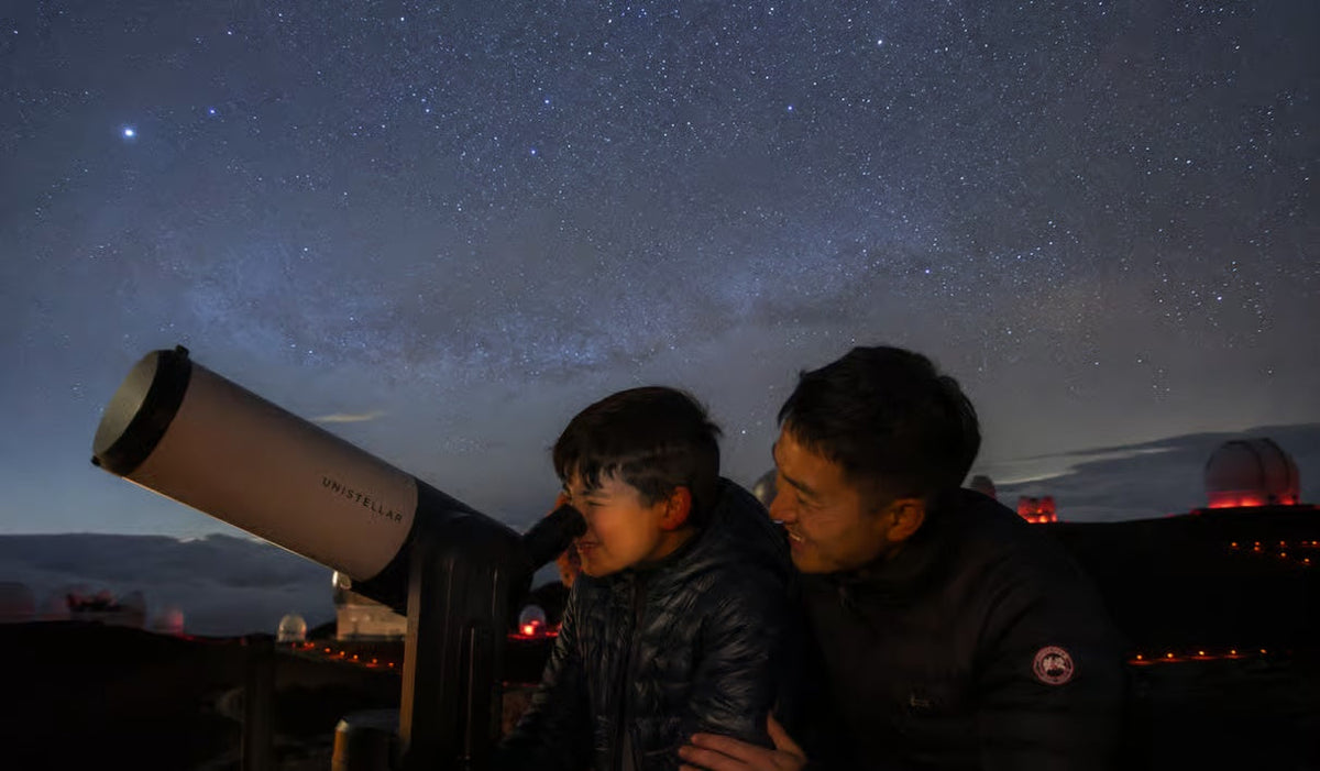 Guest looking through telescope under the Hawaiian stars