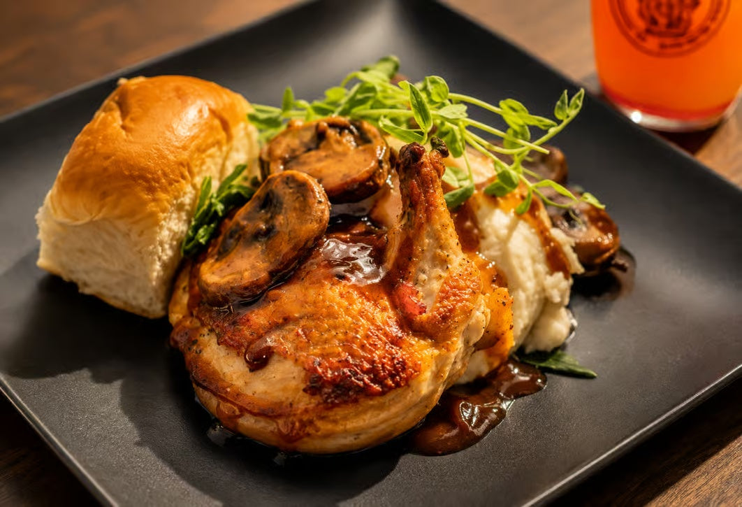 Plated roast chicken dinner with mushrooms and bread for a sunset dinner cruise