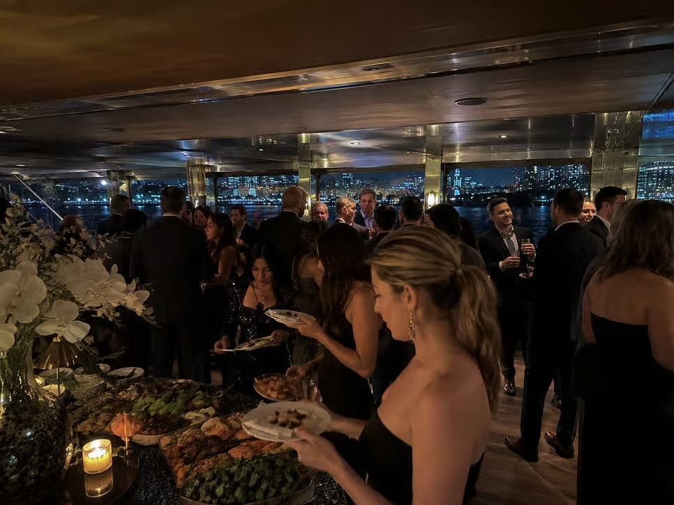 Guests enjoying buffet dinner and party atmosphere aboard a New York New Year's Eve cruise