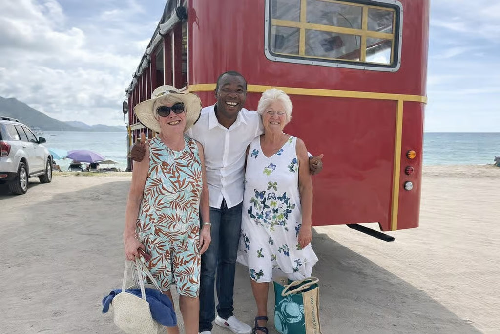 Local Saint Lucia guide posing with travelers near the beach on an island excursion