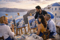 Private Santorini painting workshop with an artist guiding guests at easels overlooking the caldera